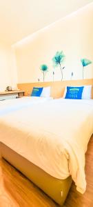 Postel nebo postele na pokoji v ubytování Qlio Hotel