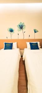 Postel nebo postele na pokoji v ubytování Qlio Hotel