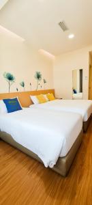 Postel nebo postele na pokoji v ubytování Qlio Hotel