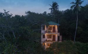 a house in the middle of the forest at night at Green Escape Unawatuna in Unawatuna