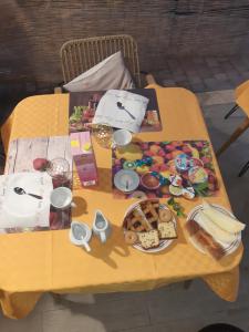 a yellow table with food on top of it at la dimora degli angeli in Perugia