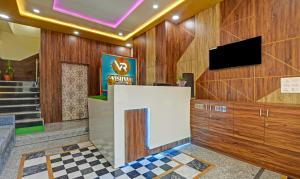 a lobby with wooden walls and a flat screen tv at Hotel Vishvam Residency Udaipur in Udaipur