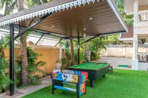 awning over a pool table in a backyard at Villa Calangute Phase 2 in Calangute +49 photos