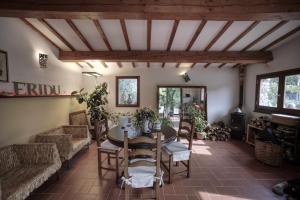 a living room with a table and chairs at B&B Eridu in Fiesole