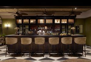 a bar with a man standing behind a counter at Zambezi Grande Private Game Experience in Mafuta