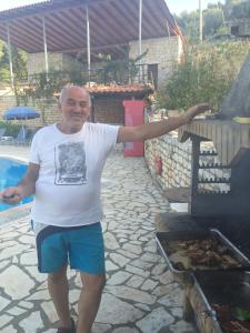 a man standing in front of a grill at Room in BB - The Quality And Hospitalityof Apraos Bay Hotel Has Been Identified in Apraos