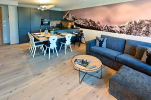 a living room with a blue couch and a table at Bergkind in Garmisch-Partenkirchen