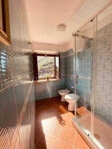 a bathroom with a toilet and a glass shower at Da Nonna Pasqualina in Ciorlano