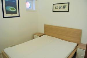 a bedroom with a bed and two pictures on the wall at D2 Apartment Budapest in Budapest