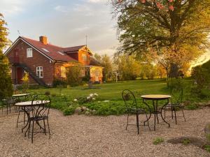a group of tables and chairs in front of a house at Villa Sandby B&B in Borrby