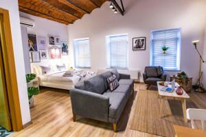 a living room with a couch and a bed at Flats Company Ajda Apartment in Istanbul