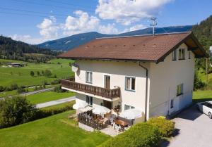 an aerial view of a house with mountains in the background at 10-Bedroom House near Obertauern for 30 people in Radstadt