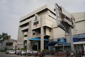 a building with motorcycles parked in front of it at Collection O 1735 Adika Bahtera Hotel in Balikpapan