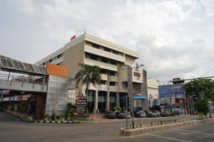 a building on the corner of a city street at Collection O 1735 Adika Bahtera Hotel in Balikpapan