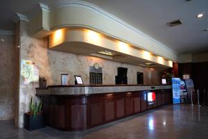 a lobby with a bar in a building at Collection O 1735 Adika Bahtera Hotel in Balikpapan