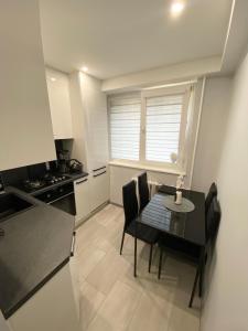 a kitchen with a table and chairs in a kitchen at Studio flat in Panevezys in Panevėžys