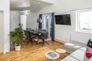 a living room with a table and a couch at Falcon Suites Kaprun - Summercard included in Kaprun