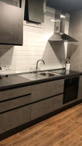 a kitchen counter with a sink and a stove at Casa Renata in Foggia