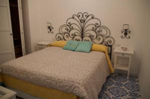 En eller flere senge i et værelse på il Porto Capri Casa Vacanza