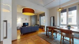 a living room with a dining table and a couch at Charming studio in Les Pâquis close to the famous Jet d'eau in Geneva