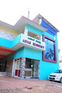 a building with a car parked in front of it at Aryan residency in Māvalli