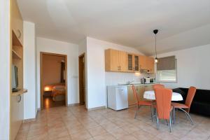 a kitchen and living room with a table and chairs at Apartments Branimir in Murter +42 photos