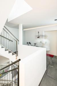 a modern house with white walls and a staircase at Falcon Suites Kaprun in Kaprun