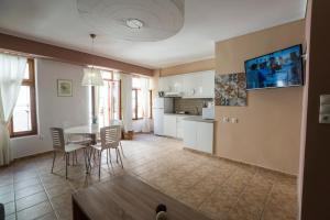 a kitchen and living room with a table and chairs at Horizon Deluxe House in Chania