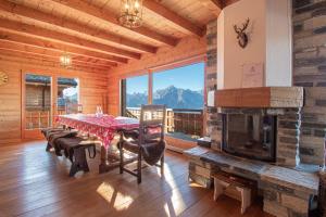 a dining room with a table and a fireplace at Hirondelle JACUZZI & LUXURY chalet 12 pers by Alpvision Résidences in Veysonnaz