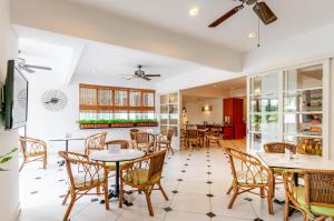 a dining room with tables and chairs at Wedgewood Residences in Kuala Lumpur