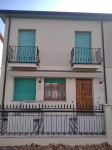 a white house with two balconies and two doors at Darecco house in Cesenatico