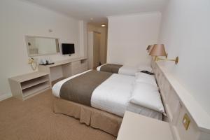 a hotel room with two beds and a television at Bay View Hotel in Killybegs