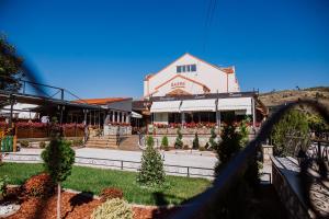 a building with a garden in front of it at Hotel Kapri in Bitola