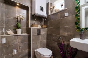 a bathroom with a toilet and a sink at Apartment & Room Lady O in Dubrovnik