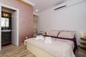 a bedroom with a bed with towels on it at Apartment & Room Lady O in Dubrovnik
