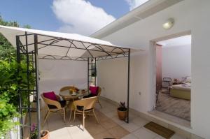 a patio with a table and chairs on a balcony at Apartment & Room Lady O in Dubrovnik