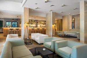 a lobby with couches and a bar at Valamar Meteor Hotel in Makarska