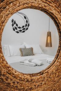 a bedroom with a bed with a mirror at Xerolithos Natural Living in Naxos Chora