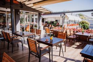 a restaurant with tables and chairs on a patio at Hotel Kapri in Bitola