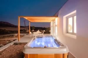 a bath tub in the middle of a house at Xerolithos Natural Living in Naxos Chora