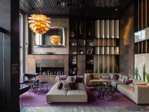 a living room with a couch and a fireplace at 11 Mirrors Design Hotel in Kyiv