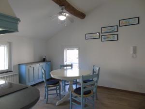 a kitchen with a table and chairs in a room at IL PERGOLATO con parcheggio privato in Genoa