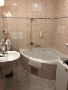 
a bathroom with a sink, toilet and bathtub at Hotel West in Bratislava
