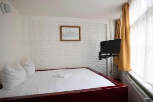 Postel nebo postele na pokoji v ubytování Hotel Internationaal
