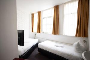Postel nebo postele na pokoji v ubytování Hotel Internationaal