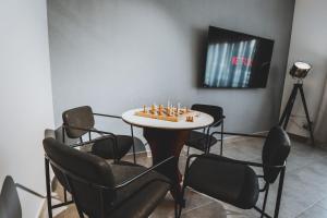 a room with a table with chairs and a chessboard on it at Mabaat - Al Shurooq 10 - 90 in King Abdullah Economic City