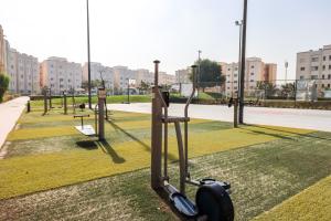 a row of exercise equipment in a park at Mabaat - Al Shurooq 10 - 90 in King Abdullah Economic City