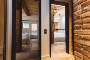 a room with two beds and a brick wall at Gut Damp Ferien Lofts in Damp +57 photos