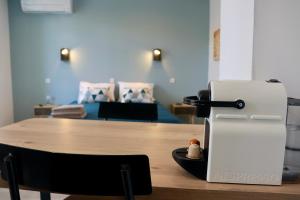 Habitación con mesa, nevera y cama. en Moulin 1- Appartement Arènes Romaines - Beziers centre - Wifi - Tv connectée en Béziers