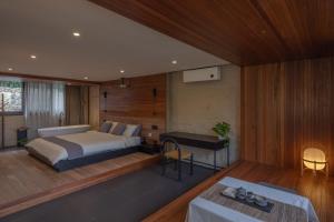 a bedroom with a bed and a desk at Yangshuo Hillside Homestay in Yangshuo